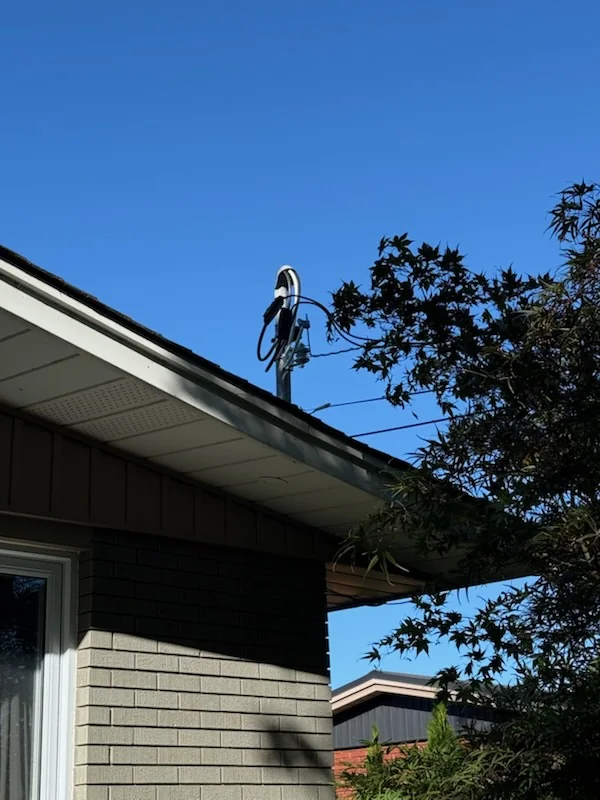 Power lines and electrical mast on roof