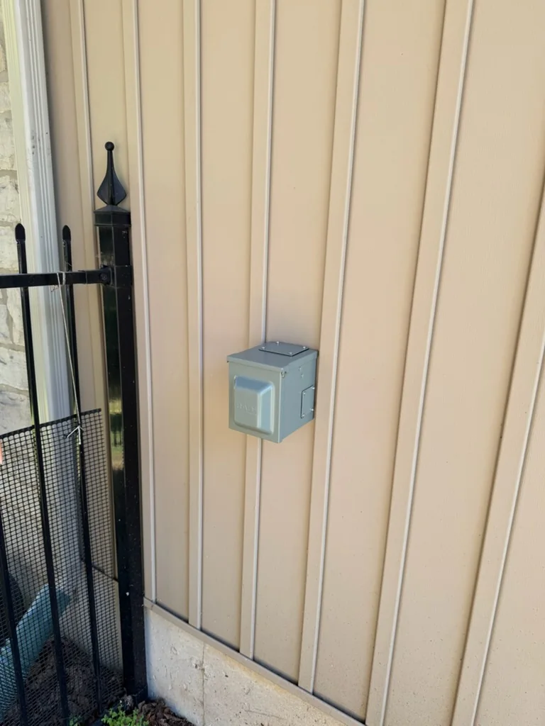 Outdoor EV charger outlet mounted on house siding