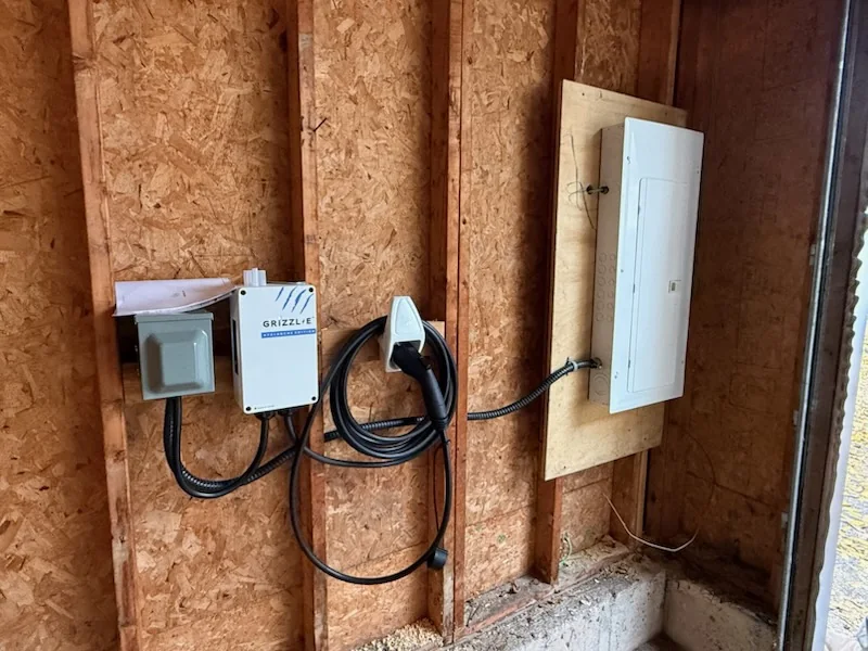 EV charger and electrical panel wiring inside unfinished wall
