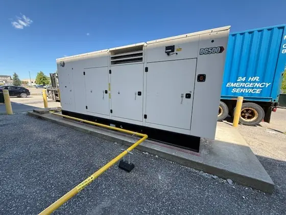 Side view of installed outdoor generator with yellow gas piping