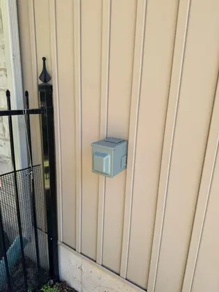 Outdoor EV charger outlet mounted on house siding